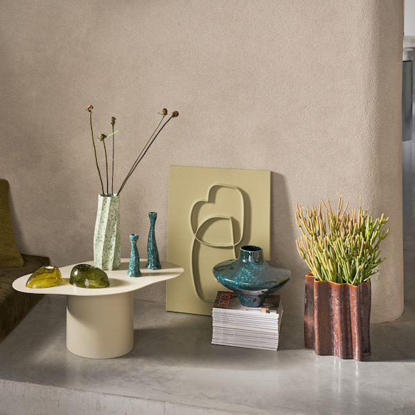 tall soft green twisted ceramic vase by Urban Nature Culture styled with sculptural decor