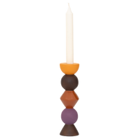 Leken totem-style candle holder in orange, red, purple and walnut displayed in modern interior