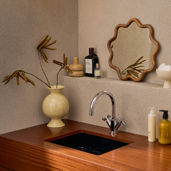 neutral speckled ceramic zody candle holder styled in bathroom shelf decor