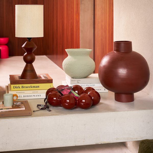 deep red ceramic sisko bowl styled on coffee table with books and vases