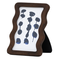 small wavy wooden photo frame styled on shelf with ceramic vases