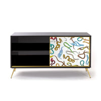 Snakes motif designer cabinet with gold legs for bold interiors
