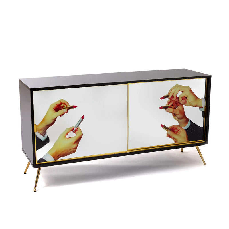 Surreal sliding door cabinet in black and gold with lipstick imagery
