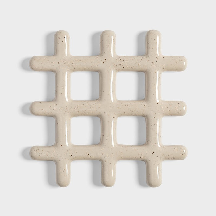 speckled beige ceramic grid trivet shown on white background
