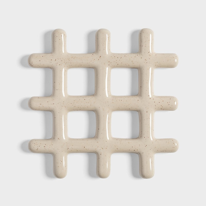 speckled beige ceramic grid trivet shown on white background
