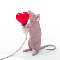 Seletti Pink Mouse Lamp holding a red heart-shaped bulb, front view