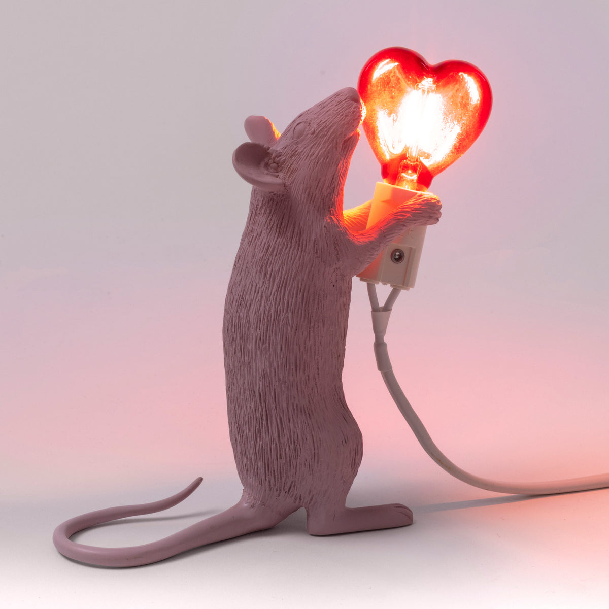 Seletti Pink Mouse Lamp with red heart bulb, styled shot