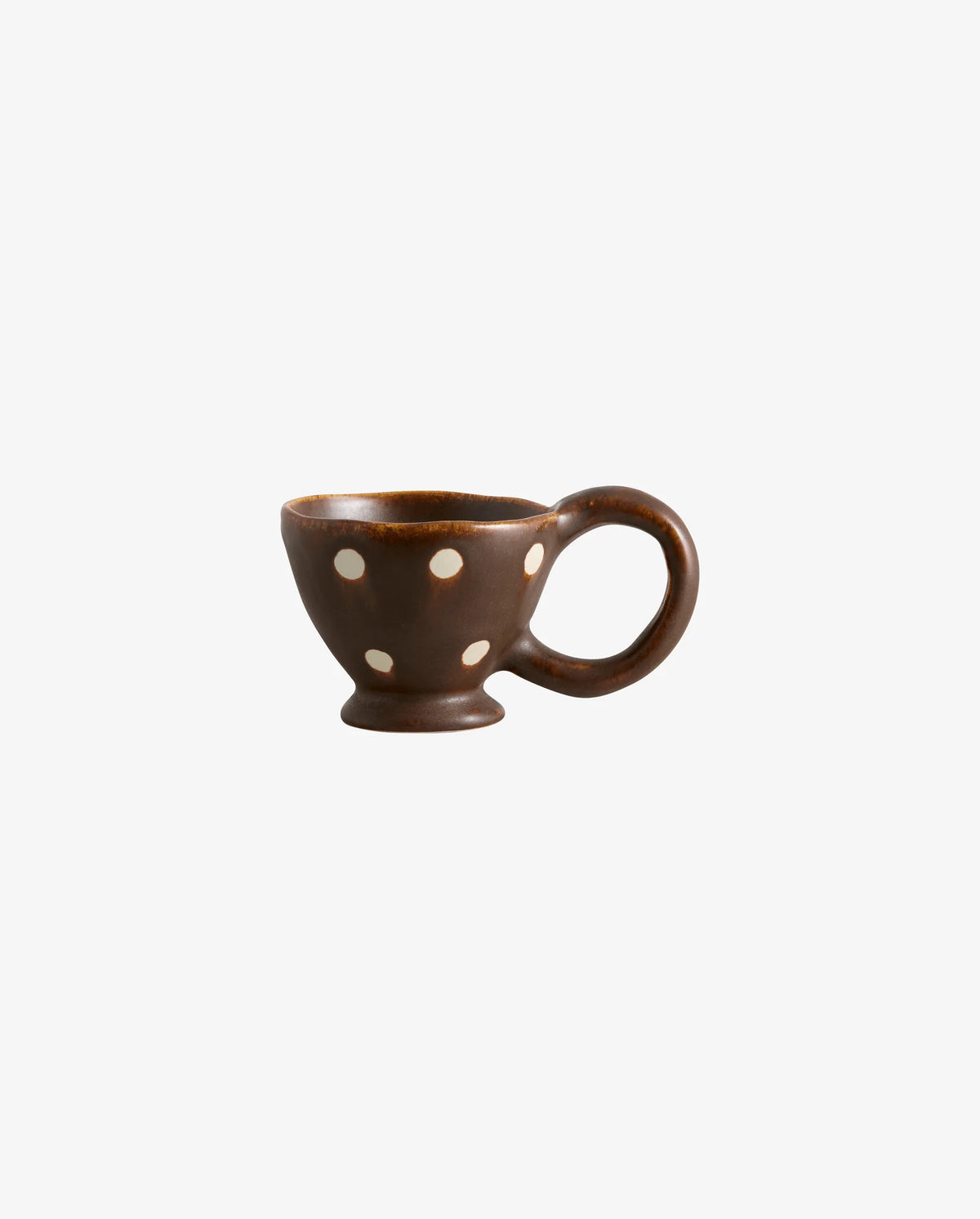 Assorted handpainted Atelier FORMA cups by Nordal displayed on a wall-mounted shelf, including the brown ZINA cup