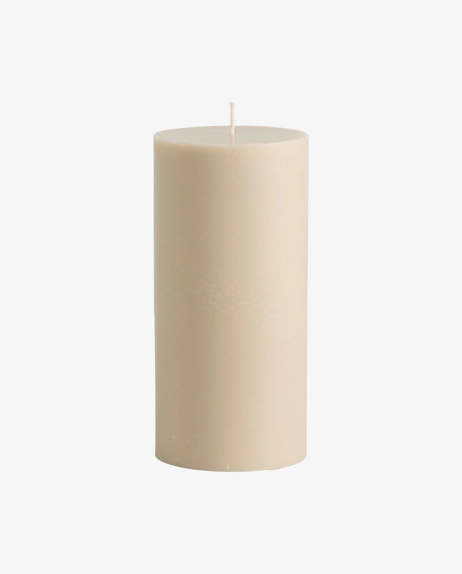 Beige pillar candle by Nordal displayed on a mantelpiece with other Nordal candles