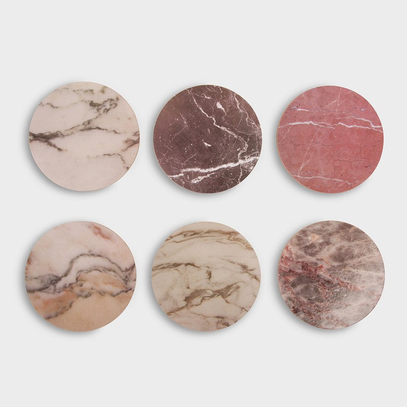 six assorted marble-pattern cork coasters displayed flat
