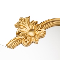 Close-up of the carved gold leaf ornament on the side of the Seletti Tetris Mirror 2.0