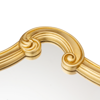 Close-up of a curved gold scroll on the Seletti Tetris Mirror 2.0 frame