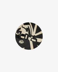 LIPSI decorative plate by Nordal in black and beige, top-down view showing the full graphic art deco pattern