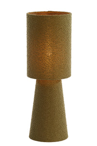 olive green boucle table lamp glowing warmly when switched on
