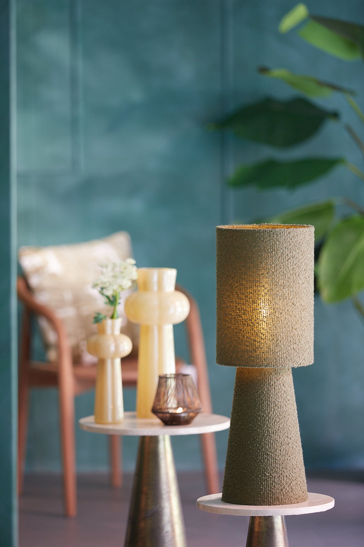 olive green boucle table lamp styled in calm interior with blue wall
