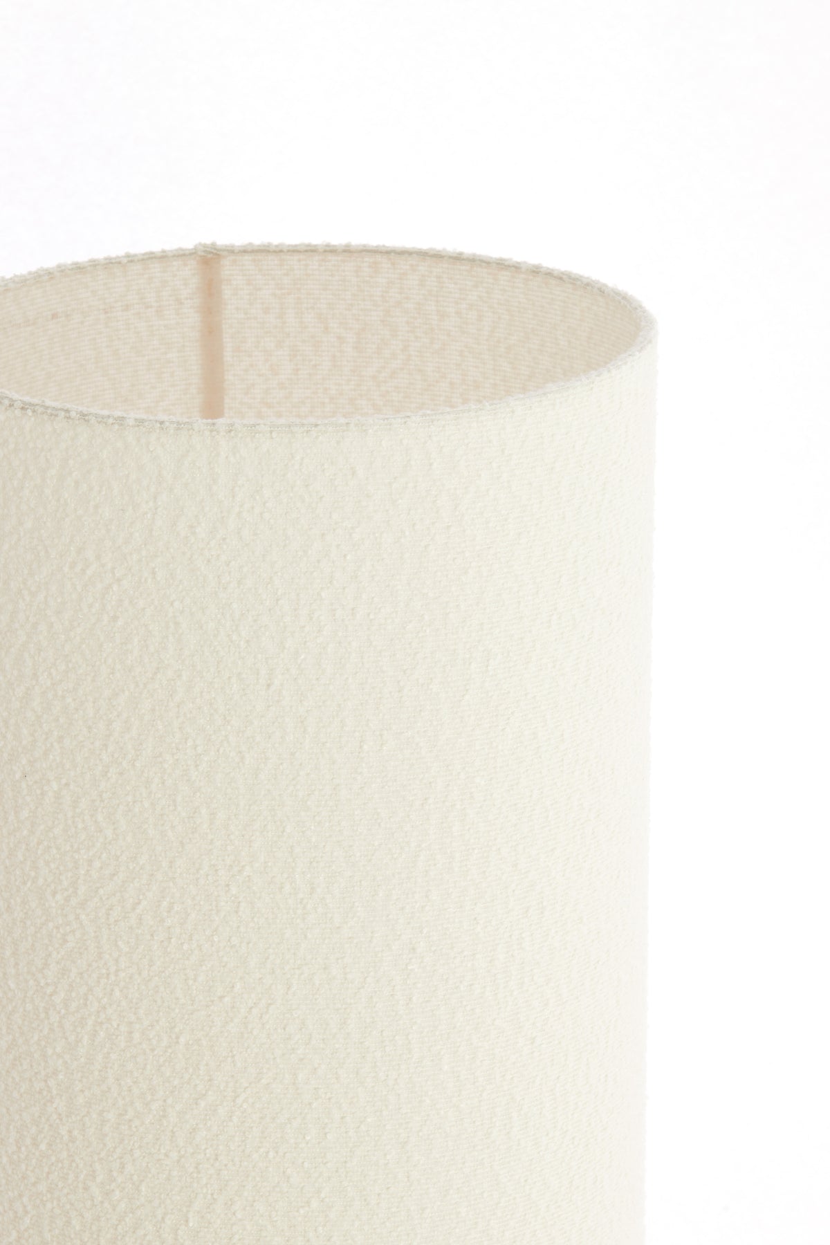 Close-up of a textured white lampshade on a white background