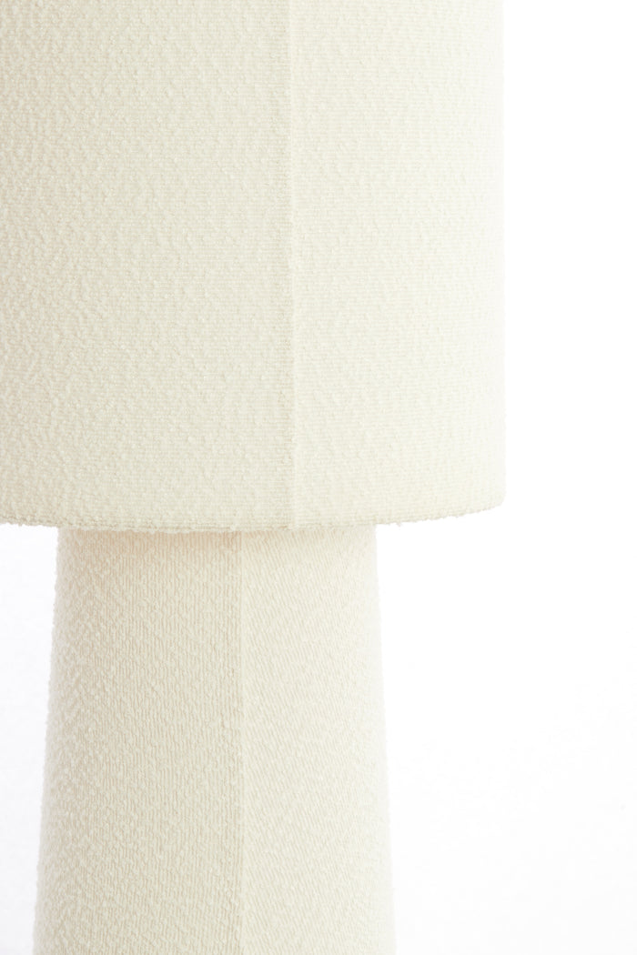 close-up of cream boucle fabric on floor lamp shade and base
