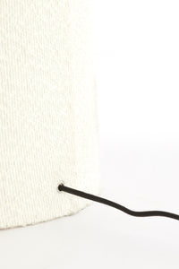 White knit beanie with a black drawstring on a white background