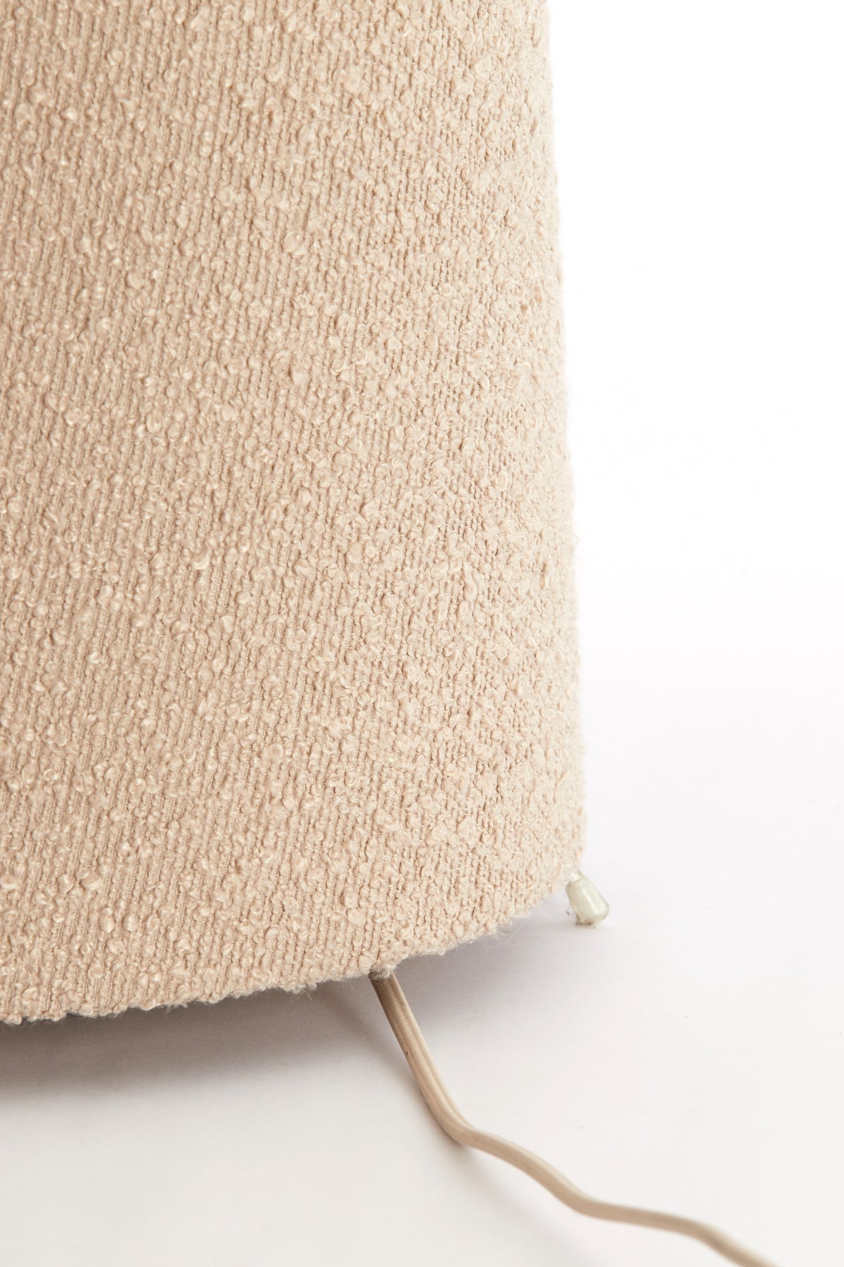 sand boucle floor lamp paired with wood and pastel accessories
