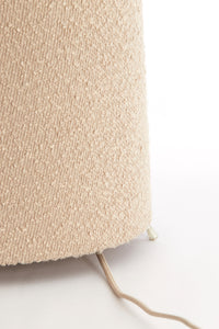 sand boucle floor lamp paired with wood and pastel accessories
