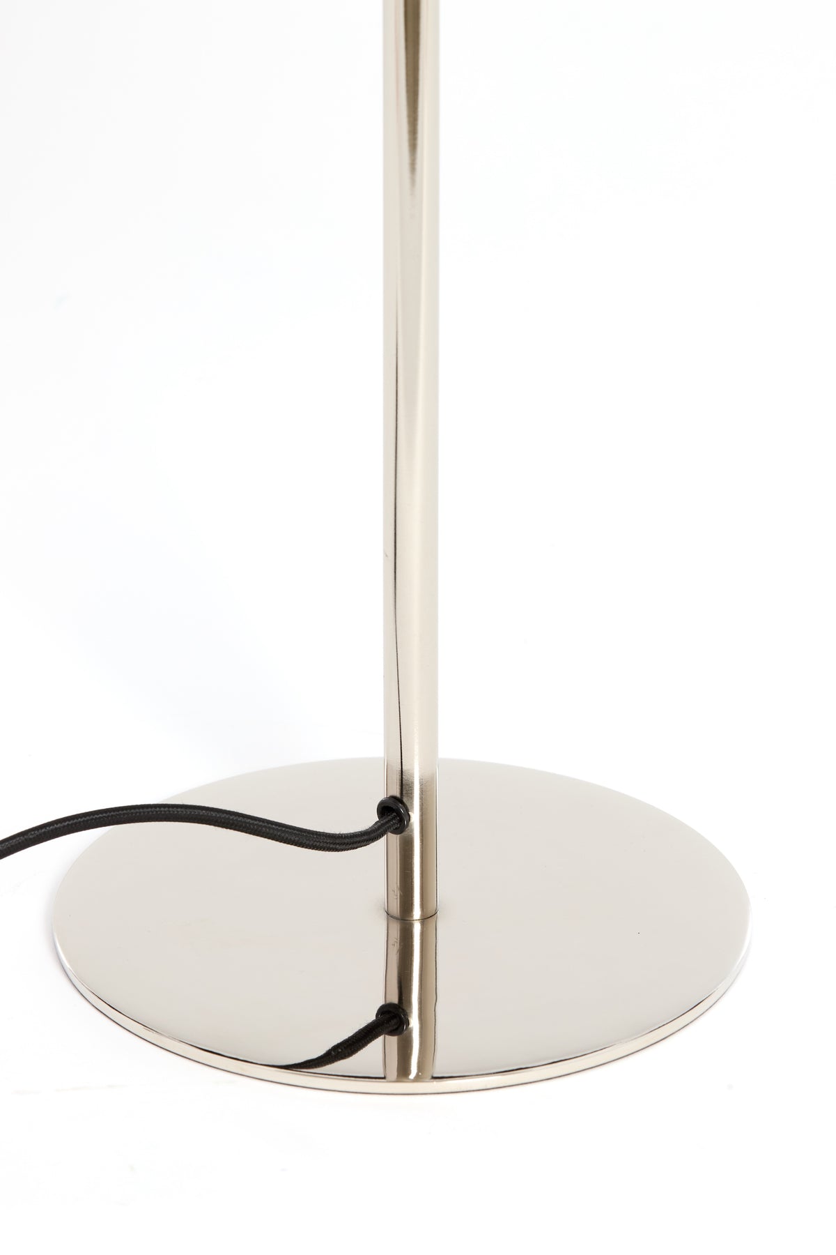 round chrome base of Surin table lamp with black fabric cable
