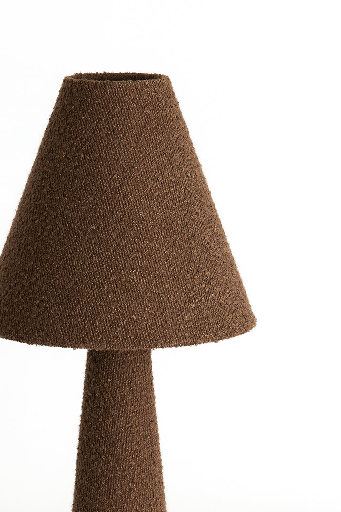 Close-up of brown bouclé fabric on the DEVIA floor lamp shade.

