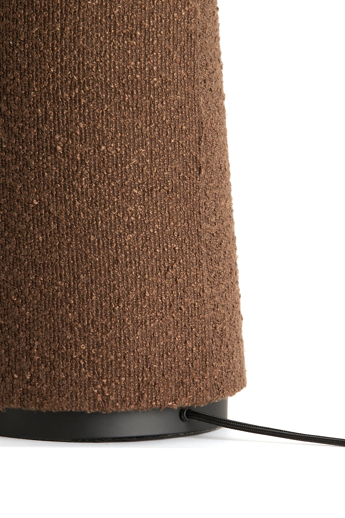 Detail of the textured bouclé base on the DEVIA brown floor lamp.
