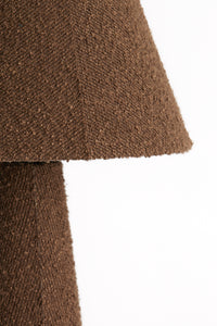 Side view showing the conical shade and texture of the DEVIA bouclé floor lamp.
