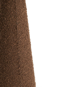 Lower base and cable detail of the DEVIA tall bouclé floor lamp in brown.
