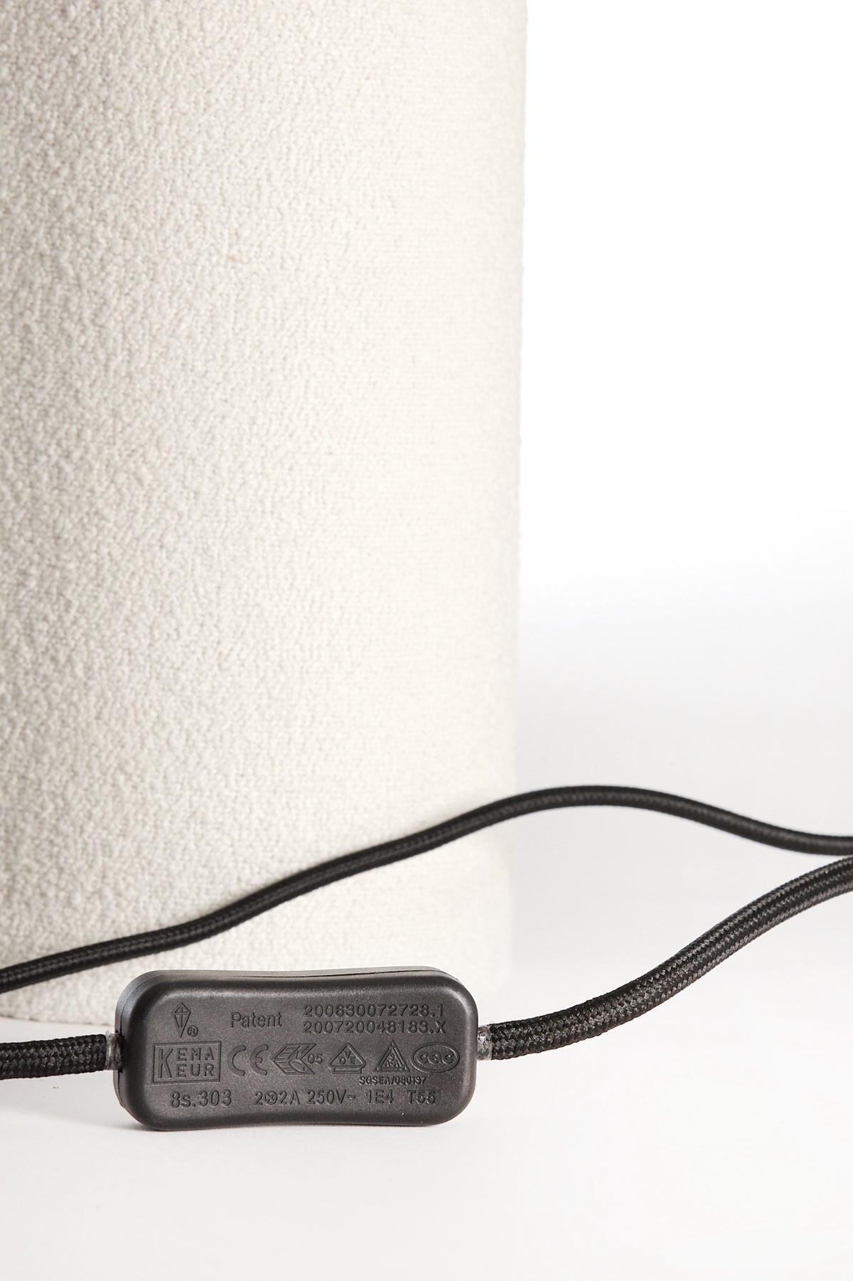 Black electrical cable with a plug on a white background