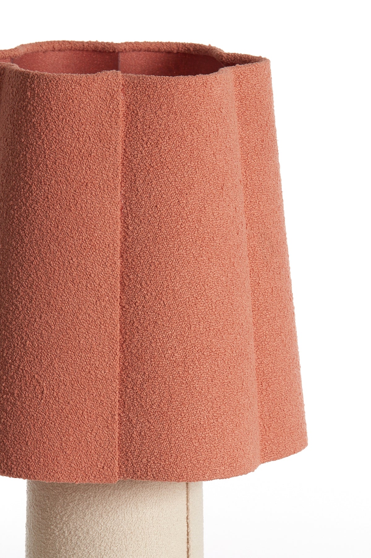 Textured pink lampshade on a white background