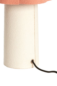 Close-up of a beige boucle fabric lampshade with a visible power cord on a white background