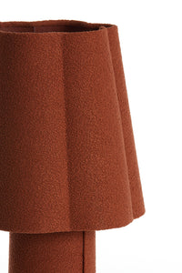 sculptural fluted shade of orange mushroom lamp in textile finish
