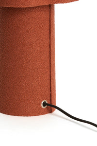 lamp base in orange textured fabric with cord outlet detail
