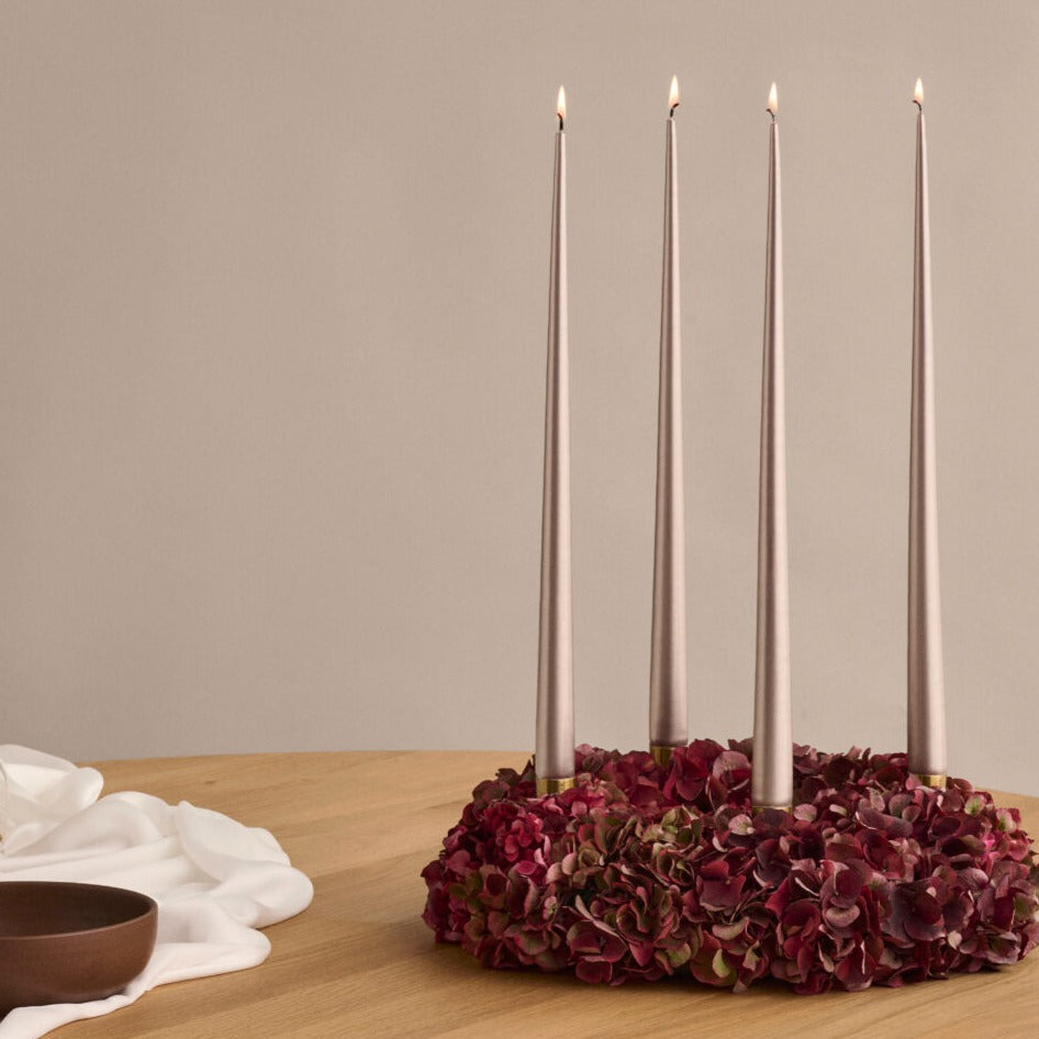 Metalic taper candles in a floral table display