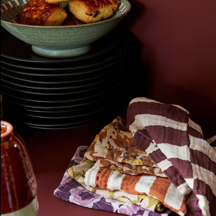 a selection of cotton different colourled cloth napkins with purples reds and oranges in 70s styles by hkliving design house for anyones table and dinnerware