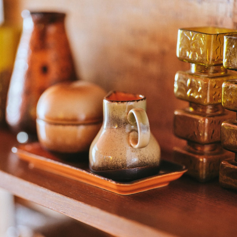 hkliving sugar pot and milk jug on a 70s coloured tray with vases on a mantlepiece