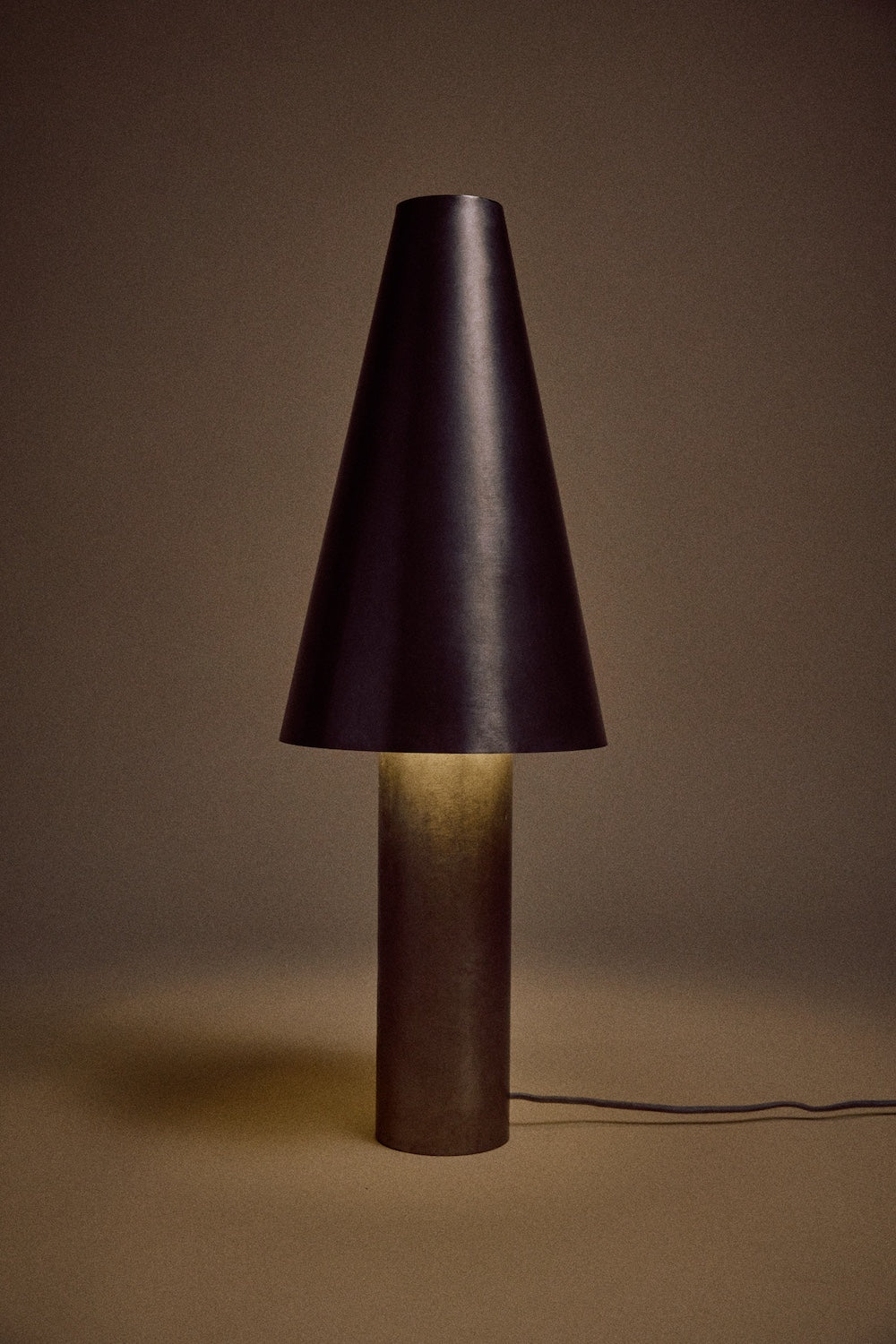 HKLIVING metal cone table lamp lit, glowing warmly against a dark brown backdrop