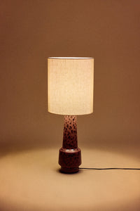 HKLIVING natural linen cylinder lamp shade lit and glowing on a maroon speckled ceramic base