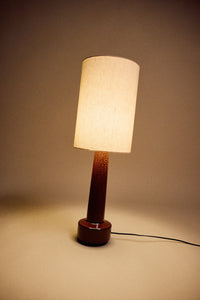 HKLIVING table lamp with natural linen shade and glazed brown stoneware base, lit against a warm brown backdrop