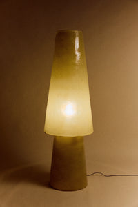 HKLIVING Glassfibre Floor Lamp in Soft Green lit in a dark room showing warm amber glow through translucent glassfibre body