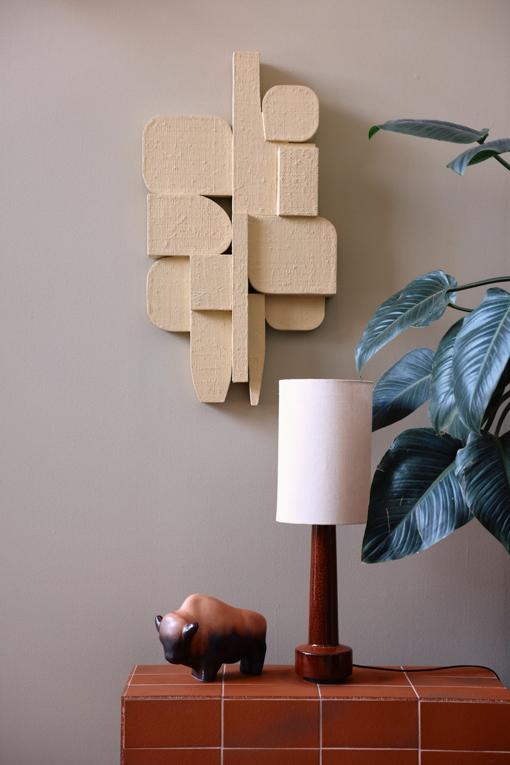 HKLIVING natural linen lamp shade on a table lamp styled beneath a cream textured wall sculpture and green plant