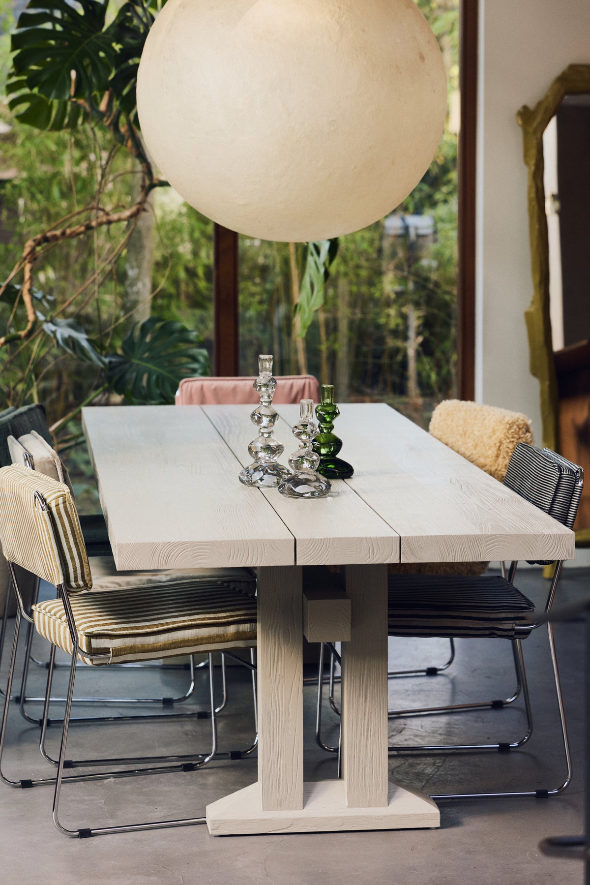 Dining room with Nienke Sikkema glass candle holders on the table under a paper pendant light