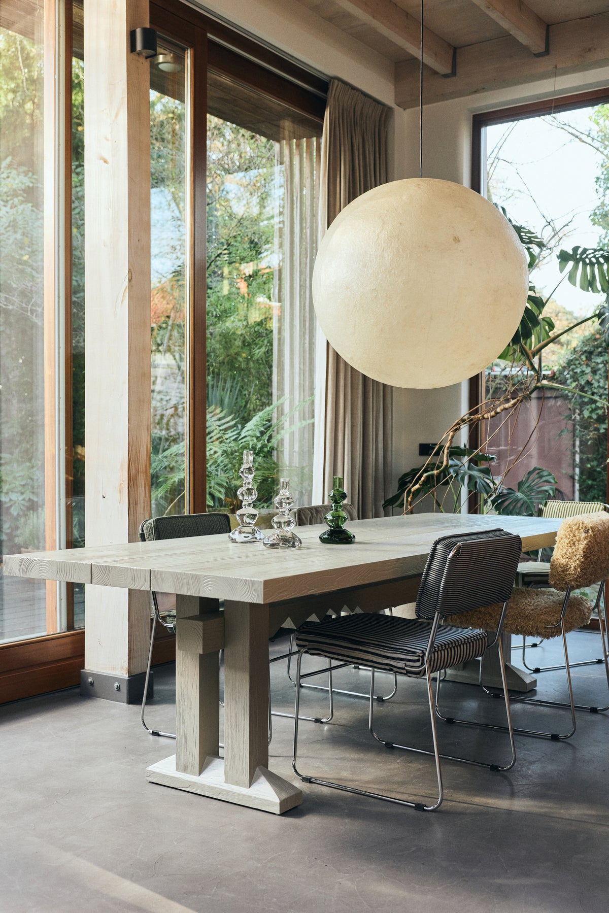 Lifestyle shot of the Forma Dining Table in Smoke by HKLIVING styled in a dining space