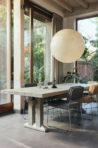 Lifestyle shot of the Forma Dining Table in Smoke by HKLIVING styled in a dining space
