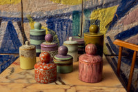 70s Ceramics storage jar in Custard displayed among a wider group of 70s ceramics storage jars in different colourways