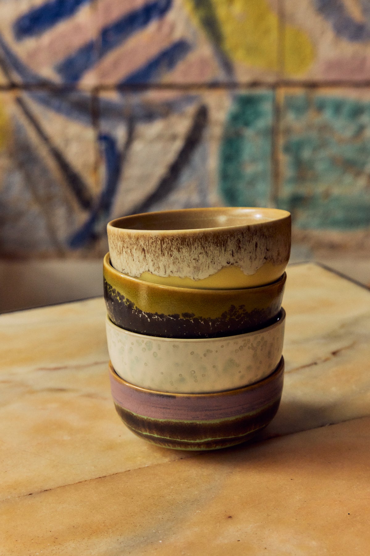 70s Ceramics tapas bowls in Sweet styled in close stacked pairs against a colourful painted tile backdrop