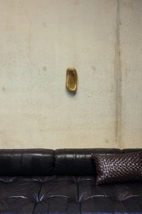 HKLIVING Glass Wall Sculpture in Moss mounted on a concrete wall above a dark leather sofa
