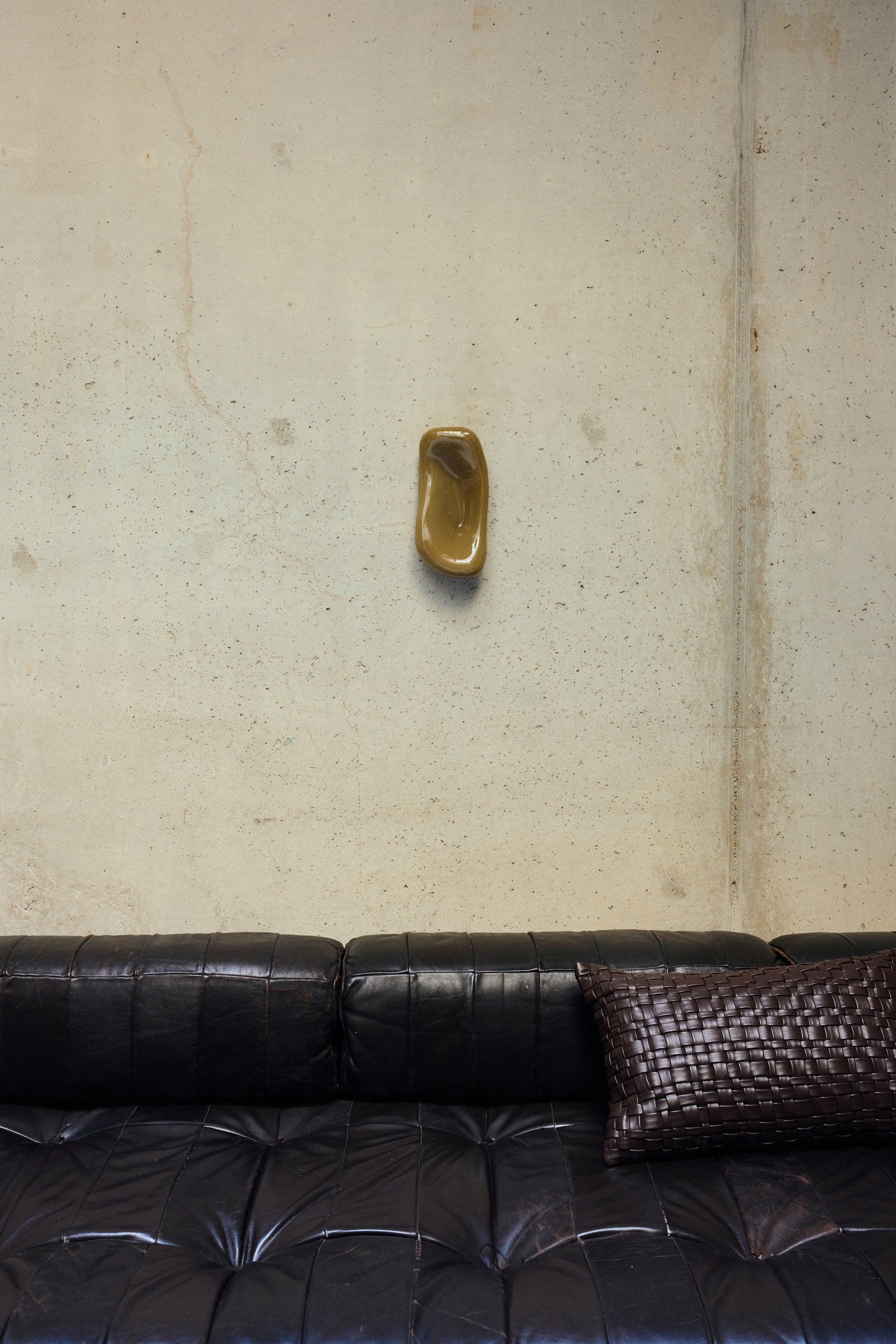 HKLIVING Glass Wall Sculpture in Moss mounted on a concrete wall above a dark leather sofa