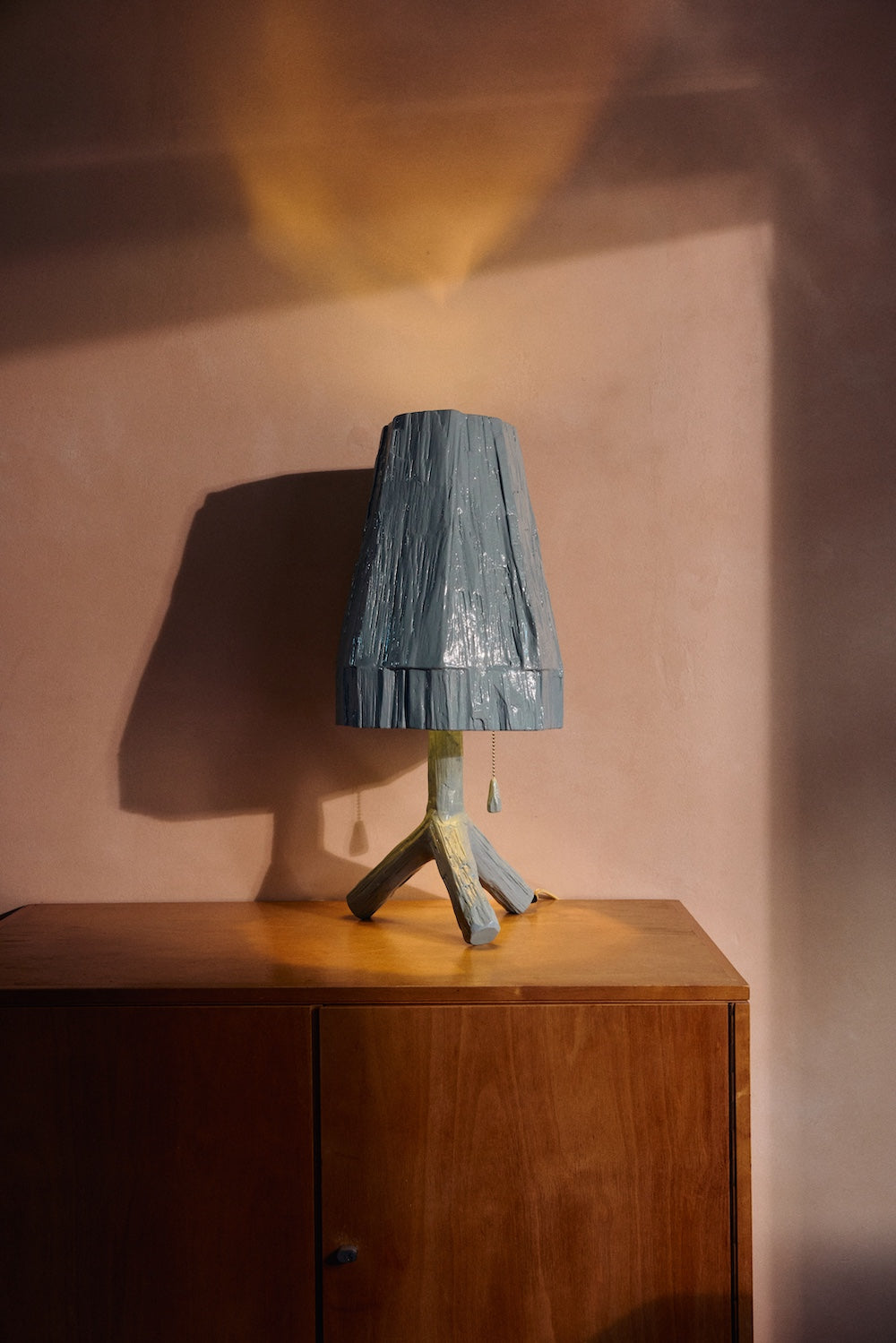 Teun Zwets for HKLIVING Sky Blue table lamp on a bedside table beside a bed with leopard print and mustard bedding
